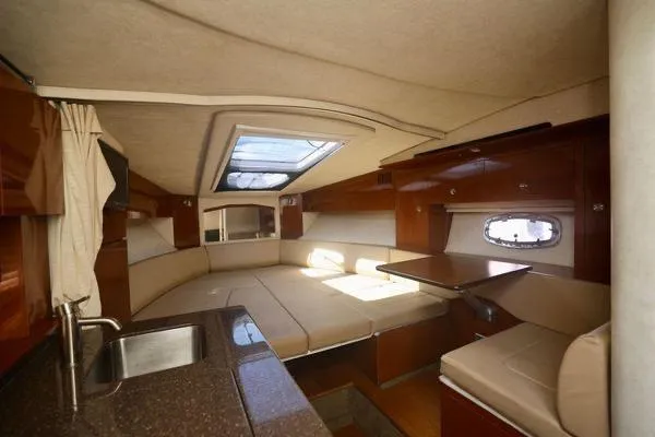 Slide: The Image of Luxurious interior of 2012 Sea Ray Sundancer 310 yacht with seating and kitchenette. - 16