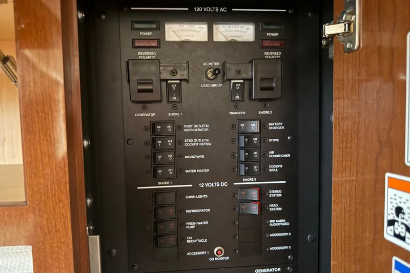Slide: The Image of Electrical control panel on a 2012 Sea Ray Sundancer 310 boat. - 22