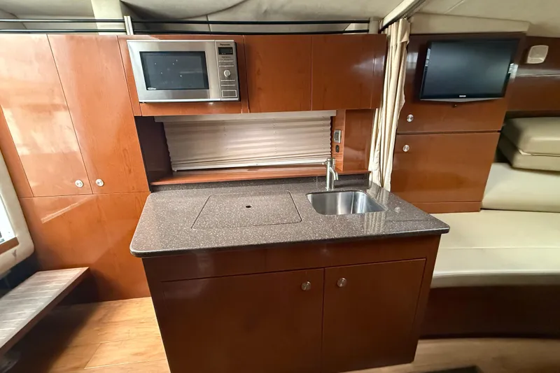 Slide: The Image of Luxurious 2012 Sea Ray Sundancer 310 yacht interior with kitchenette and modern amenities. - 24