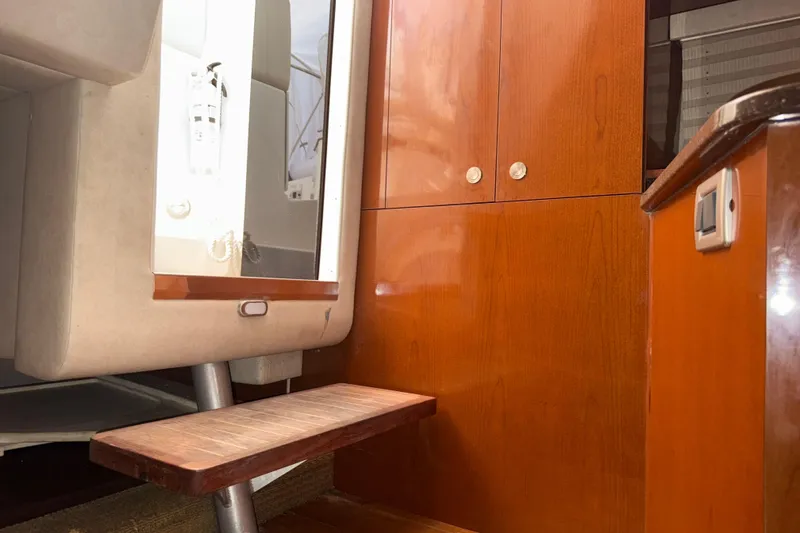 Slide: The Image of Interior of 2012 Sea Ray Sundancer 310, featuring wooden cabinetry and a small step. - 30