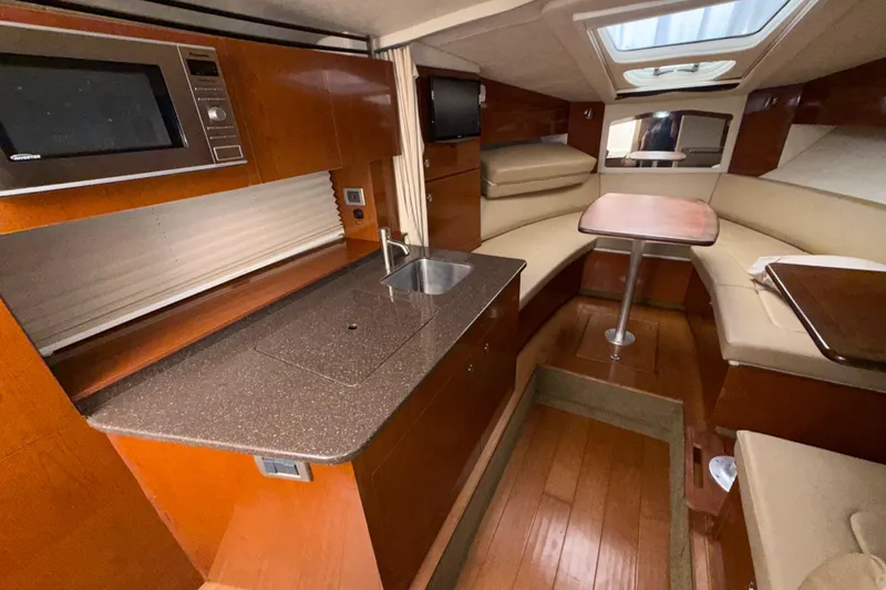 Slide: The Image of Interior of 2012 Sea Ray Sundancer 310 with kitchenette and seating area. - 31