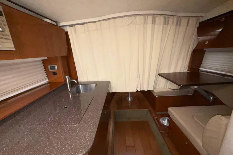 Slide: The Image of Interior of 2012 Sea Ray Sundancer 310 with kitchenette and seating area. - 32