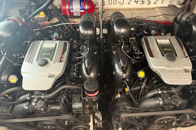 Slide: The Image of Twin engines of a 2012 Sea Ray Sundancer 310 boat, showcasing detailed mechanics. - 34