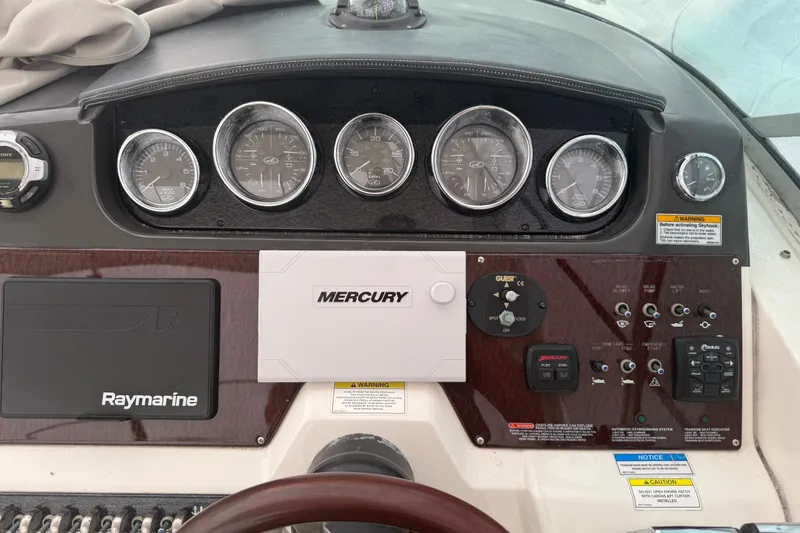 Slide: The Image of Dashboard of a 2012 Sea Ray Sundancer 310 with gauges and controls. - 5