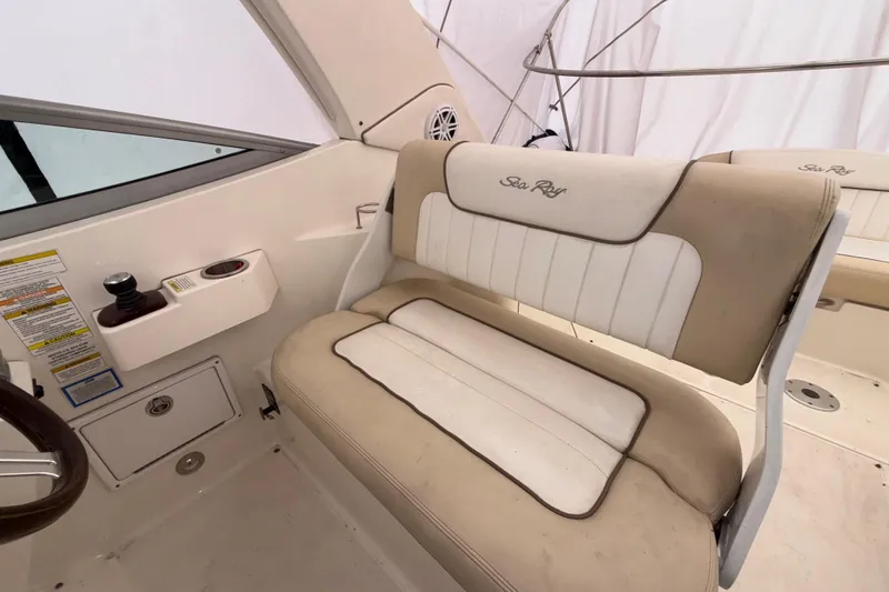 Slide: The Image of Interior seating of 2012 Sea Ray Sundancer 310 boat, featuring beige and white upholstery. - 7