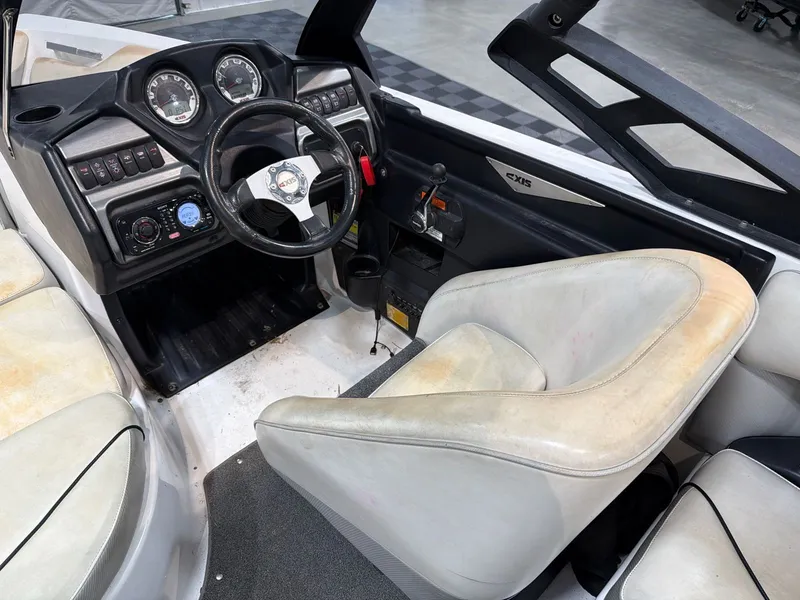 Slide: The Image of Interior of a 2011 Axis A20 boat with steering console. - 12