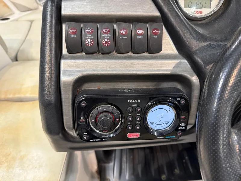 Slide: The Image of Dashboard of Axis A20 boat featuring Sony marine radio. - 14