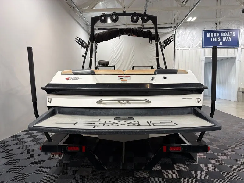 Slide: The Image of Rear view of a 2011 Axis A20 boat in a showroom. - 4
