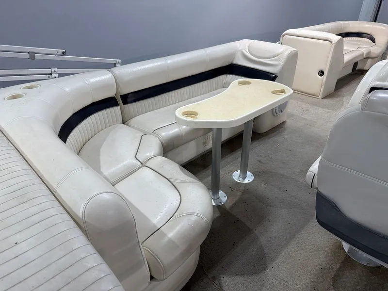 Slide: The Image of Interior of a 2007 Godfrey Aqua Patio 240RE boat with seating area. - 7