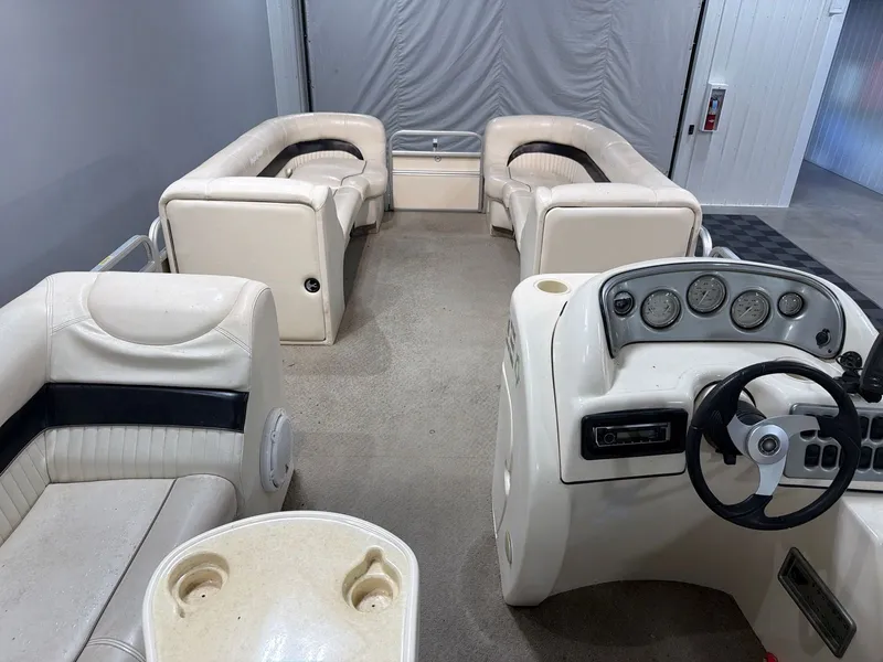 Slide: The Image of Interior of a 2007 Godfrey Aqua Patio 240RE boat with cream seating. - 8
