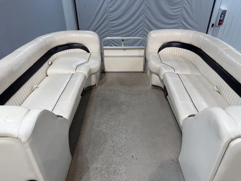 Slide: The Image of Interior of a 2007 Godfrey Aqua Patio 240RE boat with white seating. - 9