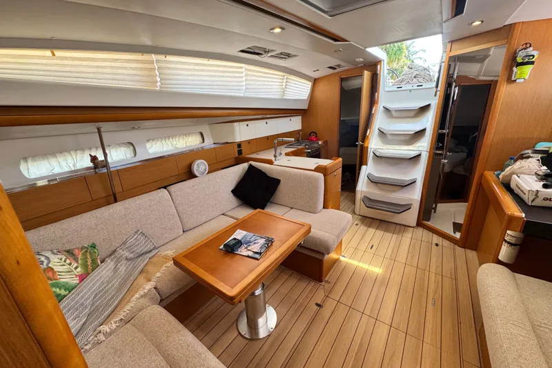 Slide: The Image of Interior of 2020 Jeanneau Sun Odyssey 44 DS yacht, featuring cozy seating and wooden finishes. - 12