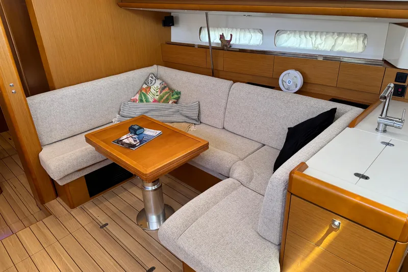 Slide: The Image of Interior of 2020 Jeanneau Sun Odyssey 44 DS yacht with cozy seating and wooden table. - 13