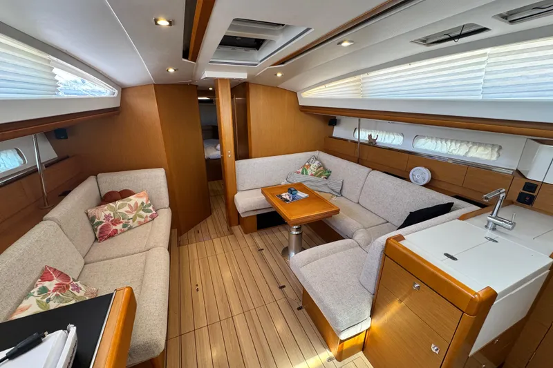 Slide: The Image of Luxurious interior of 2020 Jeanneau Sun Odyssey 44 DS yacht with elegant seating and wood finish. - 14