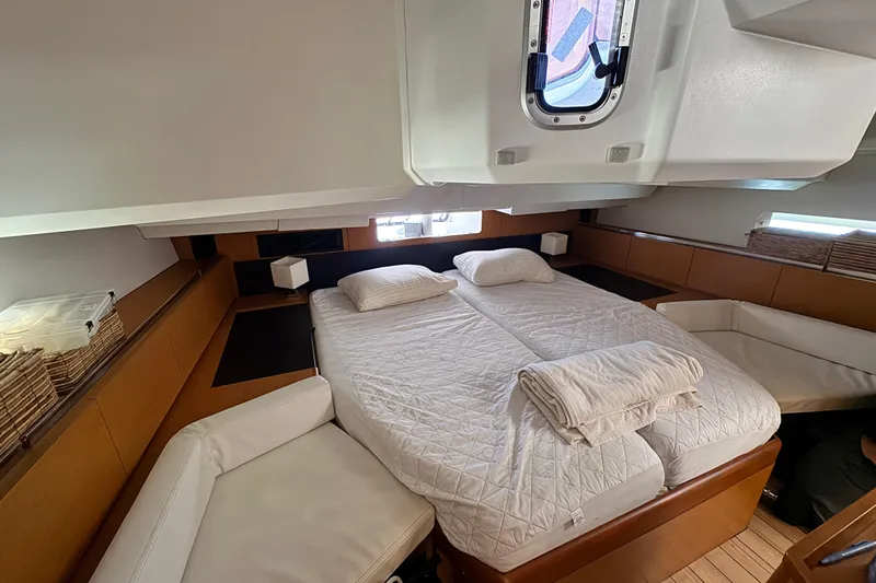 Slide: The Image of Luxurious cabin interior of 2020 Jeanneau Sun Odyssey 44 DS yacht with double bed. - 22