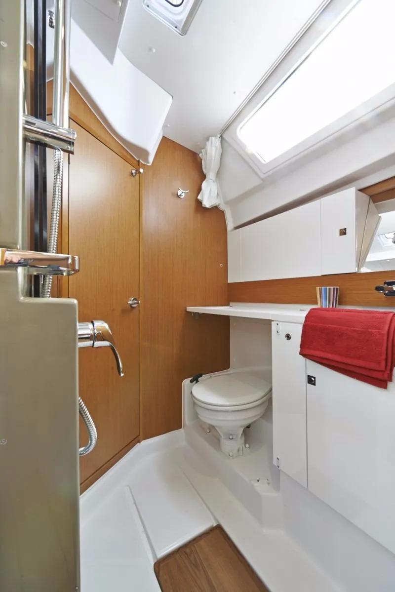 Slide: The Image of Manufacturer Provided Image: 2017 Jeanneau Sun Odyssey 44 DS bathroom with modern fixtures and wooden cabinetry. - 23