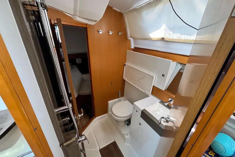 Slide: The Image of Interior of 2020 Jeanneau Sun Odyssey 44 DS yacht bathroom, featuring modern fixtures and wood accents. - 26