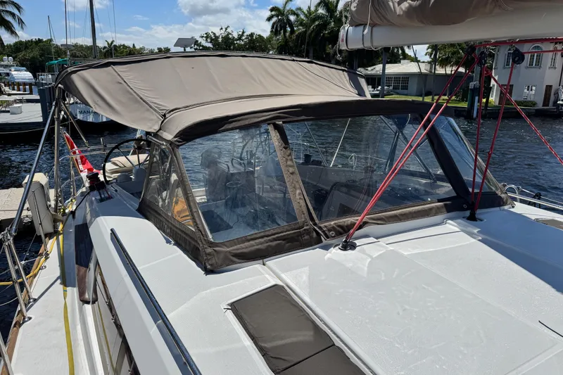 Slide: The Image of 2020 Jeanneau Sun Odyssey 44 DS sailboat with canopy docked by the water. - 5