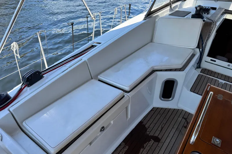 Slide: The Image of Jeanneau Sun Odyssey 44 DS 2020 yacht cockpit with cushioned seating and teak flooring. - 7