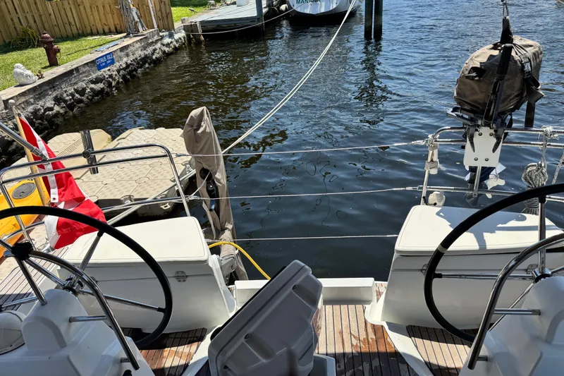Slide: The Image of Cockpit view of 2020 Jeanneau Sun Odyssey 44 DS sailboat docked by the water. - 8