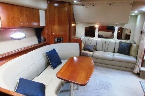 Slide: The Image of Interior of 2005 Cruisers Yachts 370 Express, featuring elegant seating and wooden accents. - 19