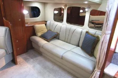 Slide: The Image of Interior of 2005 Cruisers Yachts 370 Express with beige leather seating and decorative pillows. - 22