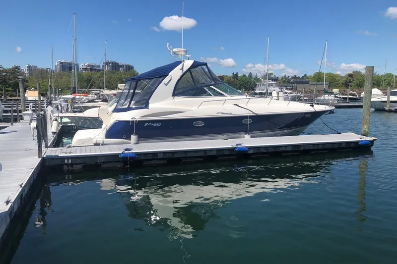 Slide: The Image of 2005 Cruisers Yachts 370 Express docked at marina under clear blue sky. - 3