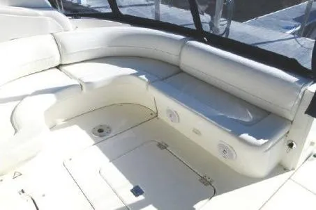 Slide: The Image of 2005 Cruisers Yachts 370 Express interior with white seating and storage compartments. - 8