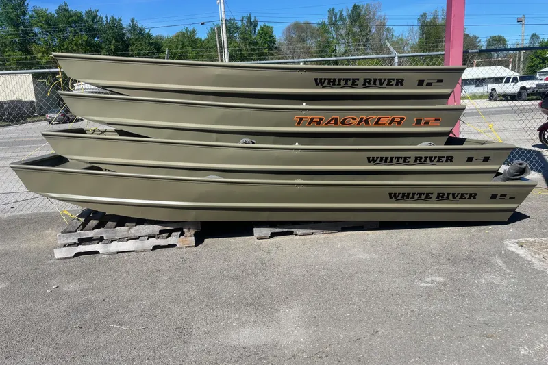The Image of Four stacked Tracker Grizzly 14 Jon boats, 2026 model, displayed outdoors. - 0