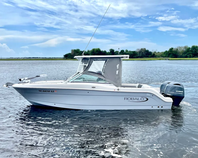 The Image of 2023 Robalo R247 Dual Console boat on calm water. - 0