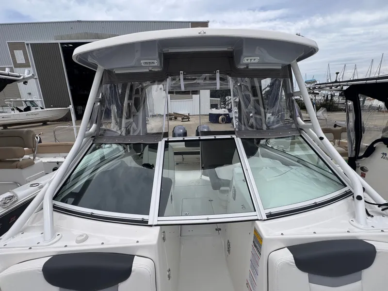 Slide: The Image of 2023 Robalo R247 Dual Console boat at the dock. - 11