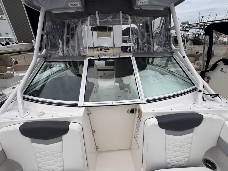 Slide: The Image of 2023 Robalo R247 Dual Console boat docked at marina. - 12