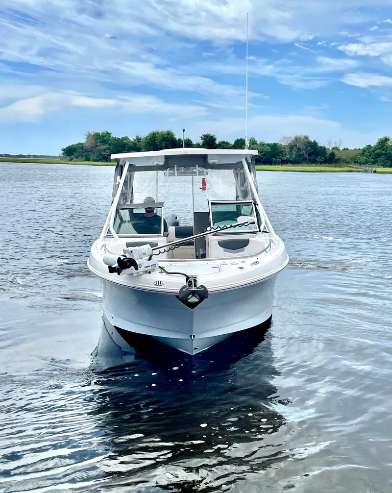 Slide: The Image of 2023 Robalo R247 Dual Console on calm water. - 3