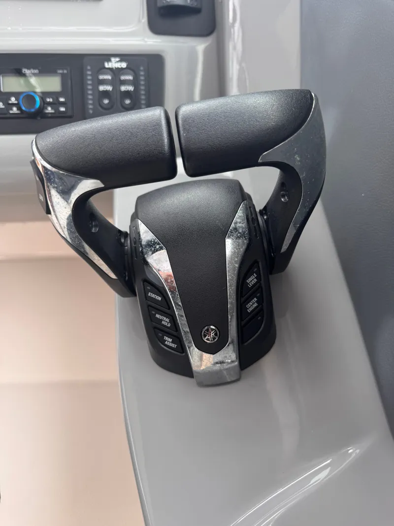 Slide: The Image of Close-up of 2023 Robalo R247 Dual Console throttle control. - 31