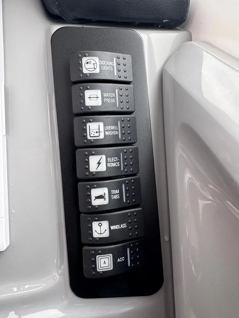 Slide: The Image of Control panel of 2023 Robalo R247 Dual Console with various switches. - 32