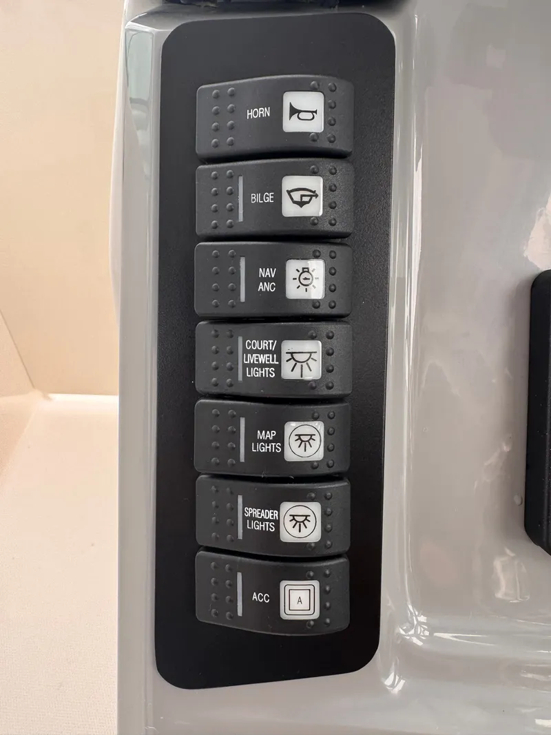 Slide: The Image of Control panel of 2023 Robalo R247 Dual Console with various switches. - 33