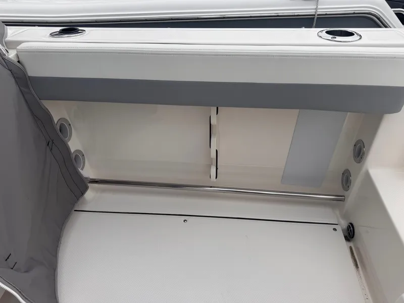 Slide: The Image of Interior of 2023 Robalo R247 Dual Console with seating and cup holders. - 34