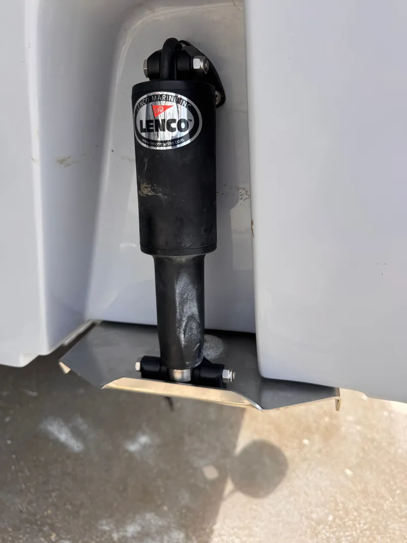 Slide: The Image of Lenco trim tab on a 2023 Robalo R247 Dual Console boat. - 37