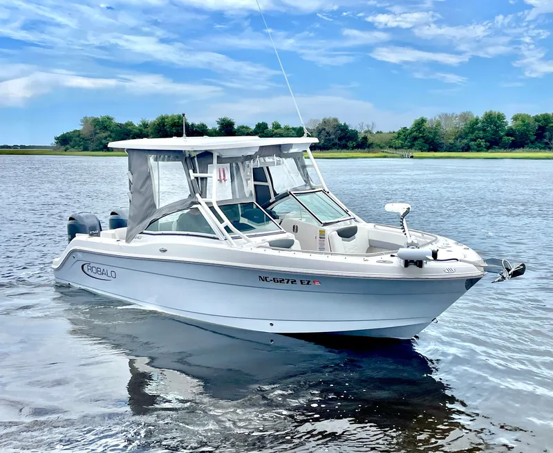 Slide: The Image of 2023 Robalo R247 Dual Console boat on calm water. - 4