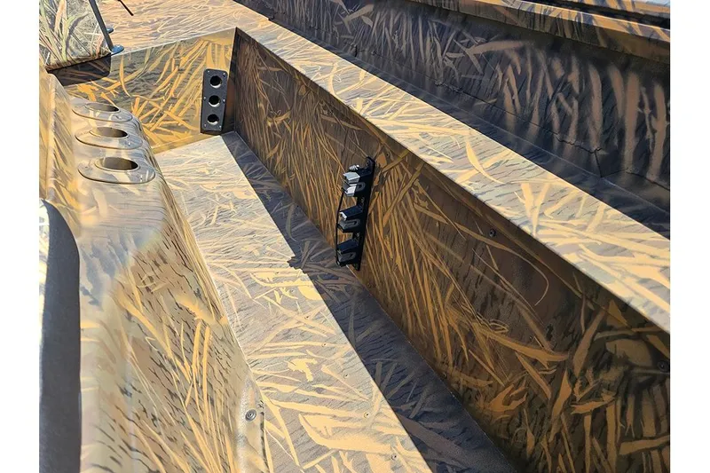 Slide: The Image of 2026 G3 Gator Tough 17 CC boat interior with camouflage design and cup holders. - 17