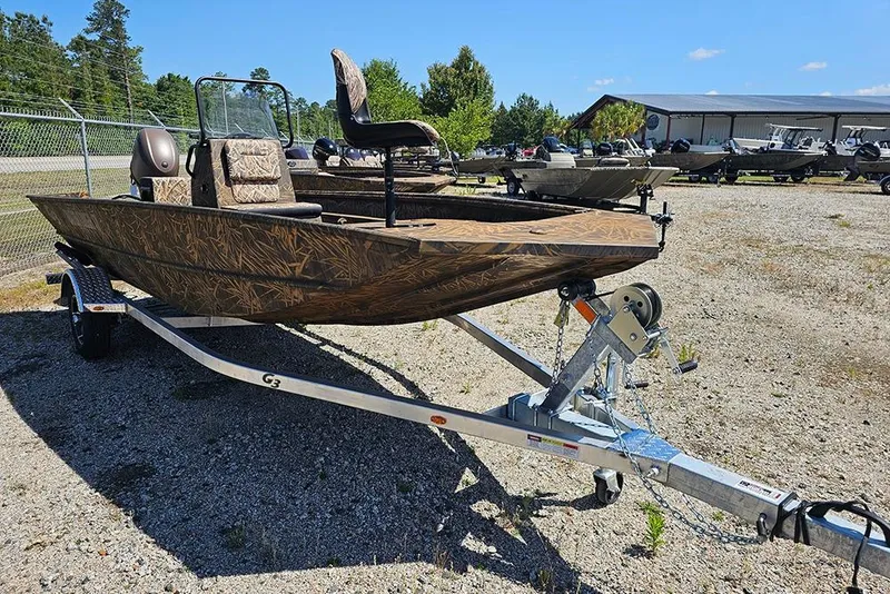 Slide: The Image of 2026 G3 Gator Tough 17 CC boat on trailer, camo design, parked on grass. - 23