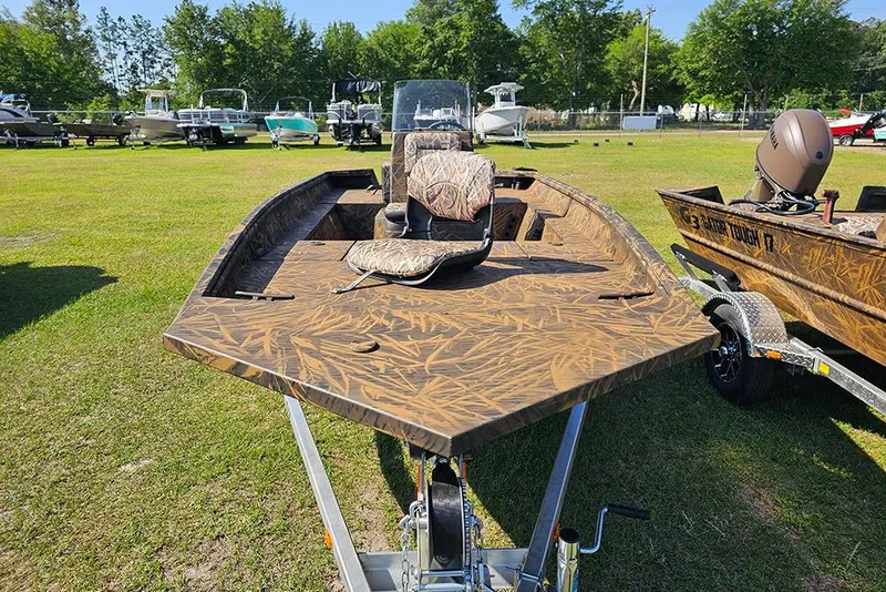Slide: The Image of 2026 G3 Gator Tough 17 CC boat with camouflage design on a grassy field. - 4