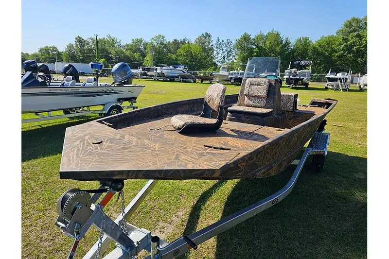 Slide: The Image of 2026 G3 Gator Tough 17 CC boat on trailer, camo design, parked on grass. - 5