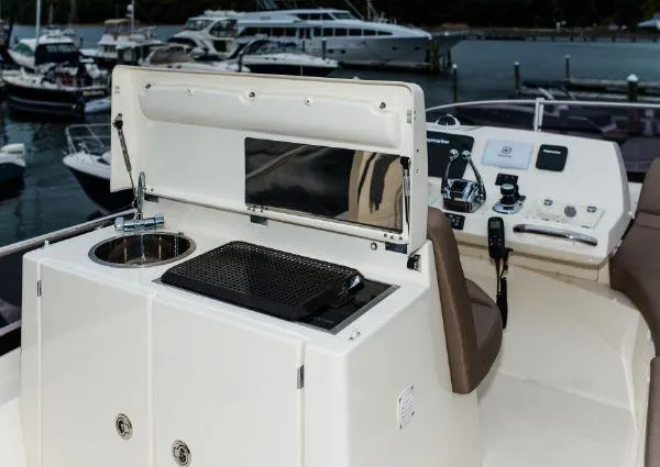 Slide: The Image of Flybridge of 2014 Prestige 550 Fly yacht with sink and grill, docked at marina. - 12