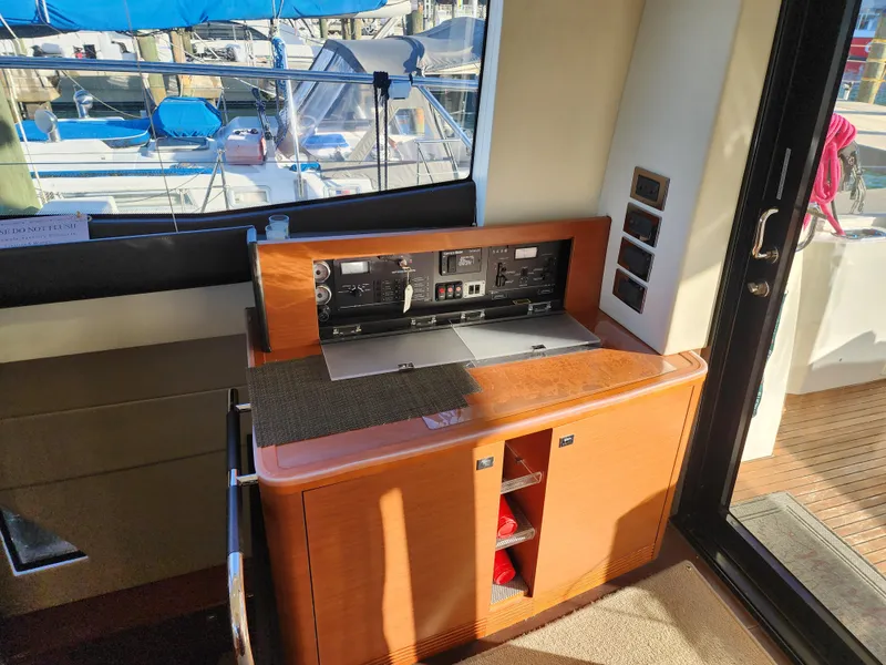 Slide: The Image of Interior view of a 2014 Prestige 550 Fly yacht with control panel and wooden cabinetry. - 17