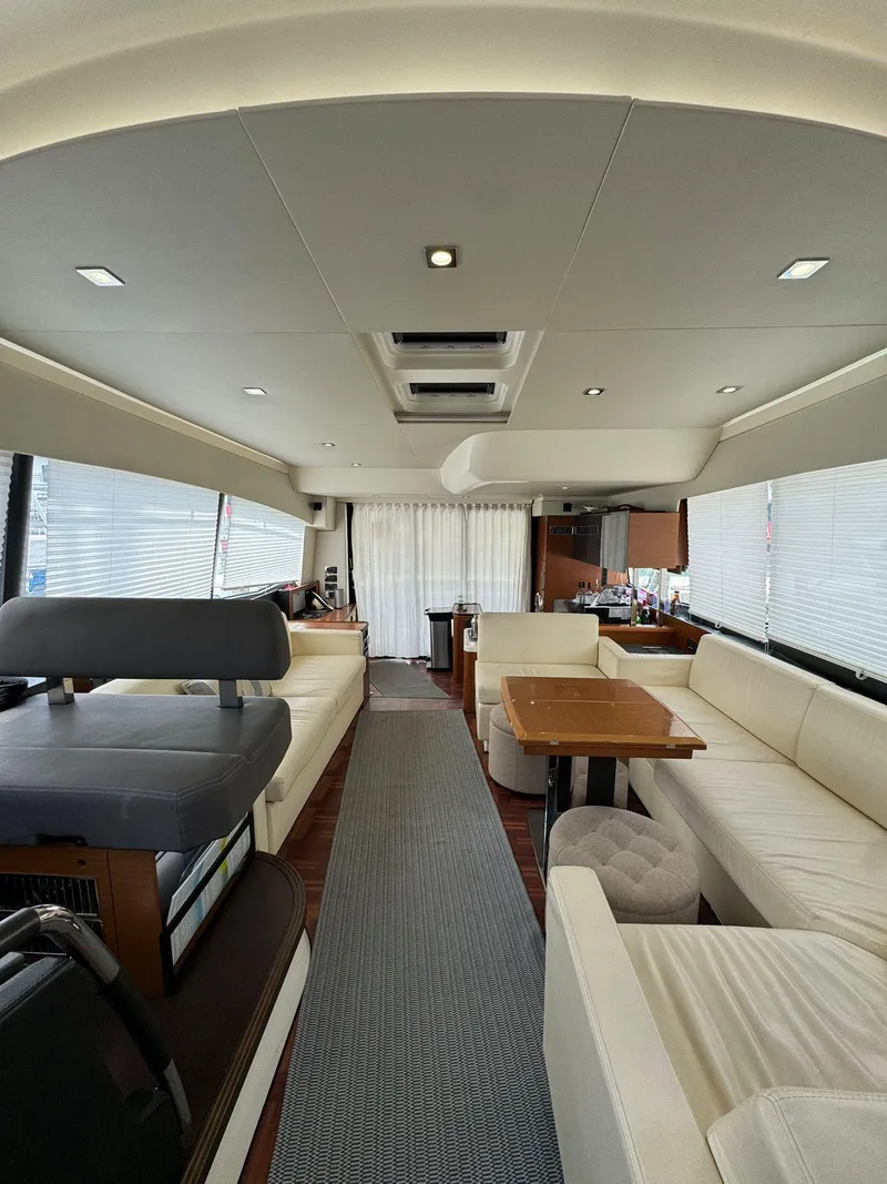 Slide: The Image of Luxurious interior of a 2014 Prestige 550 Fly yacht with elegant seating and dining area. - 19