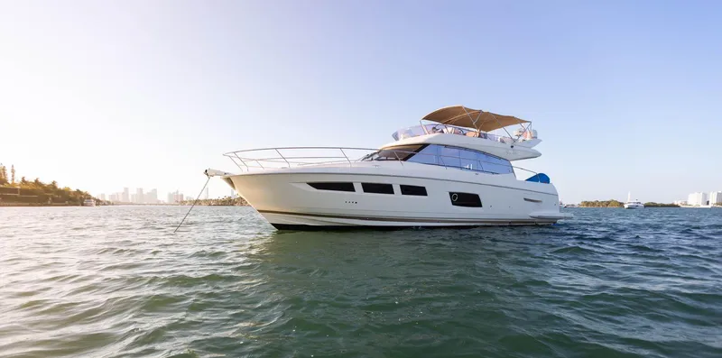 Slide: The Image of Luxury 2014 Prestige 550 Fly yacht cruising on open water. - 2