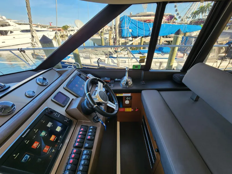 Slide: The Image of Interior view of 2014 Prestige 550 Fly yacht cockpit with modern controls and steering wheel. - 21