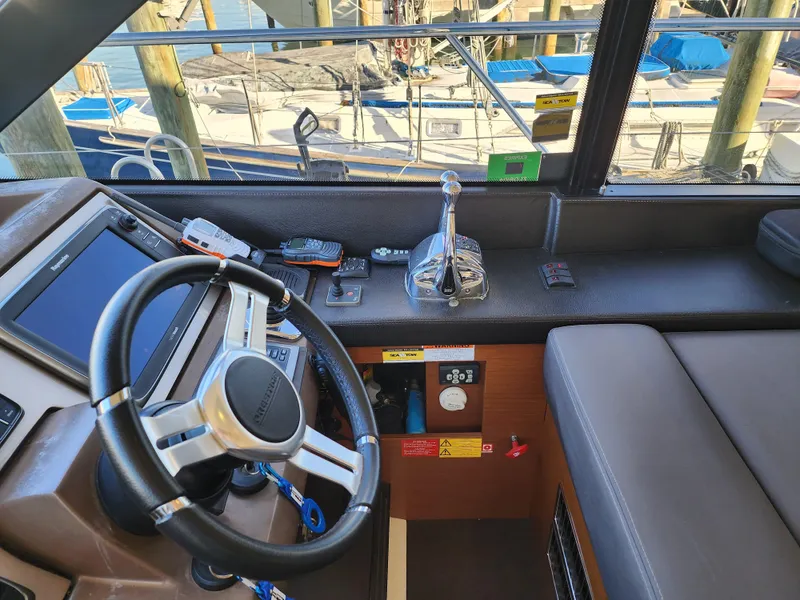 Slide: The Image of Cockpit of 2014 Prestige 550 Fly yacht with steering wheel and control panel. - 22