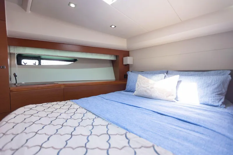 Slide: The Image of Luxurious bedroom interior of 2014 Prestige 550 Fly yacht with blue bedding. - 26